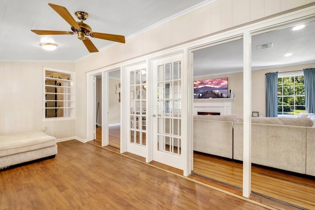 705 N 11th St, Quincy, FL 32351 - unfurnished room with crown molding, ceiling fan, wood finished floors, french doors, and a fireplace