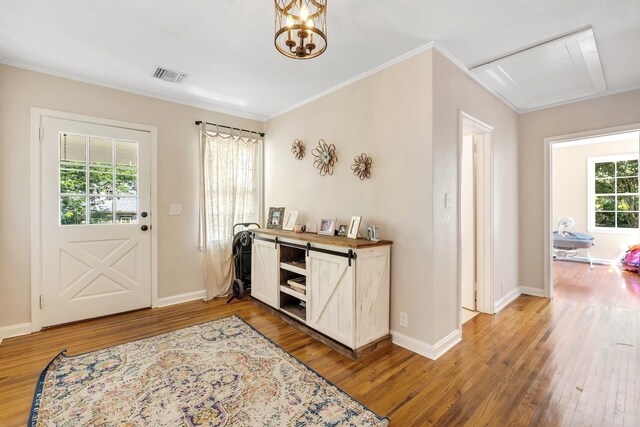 705 N 11th St, Quincy, FL 32351 - entrance foyer with light wood-style floors, ornamental molding, baseboards, and a chandelier