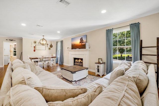 705 N 11th St, Quincy, FL 32351 - living area with ornamental molding, a chandelier, recessed lighting, wood finished floors, and baseboards