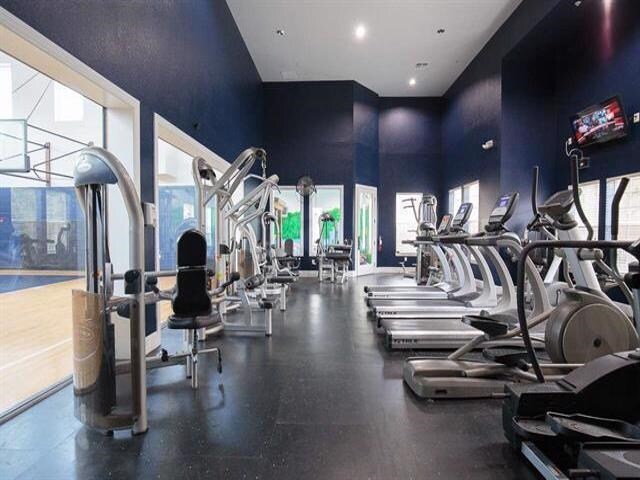 workout area featuring a high ceiling