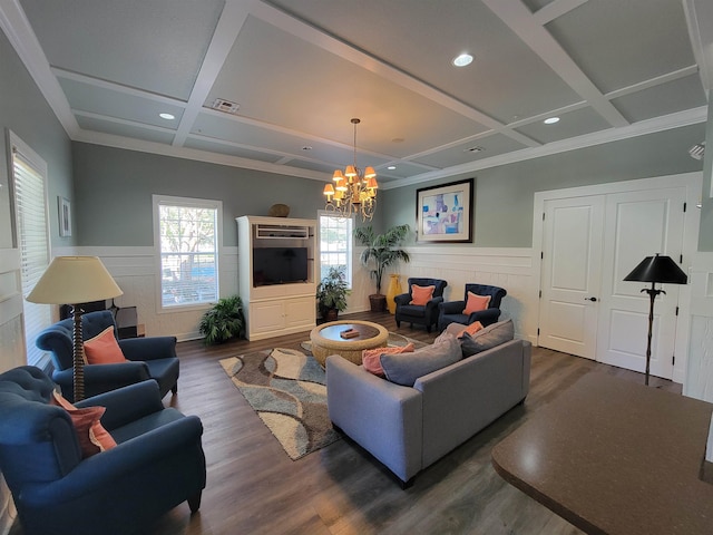 living room featuring coffered ceiling, dark hardwood / wood-style flooring, beamed ceiling, crown molding, and a chandelier