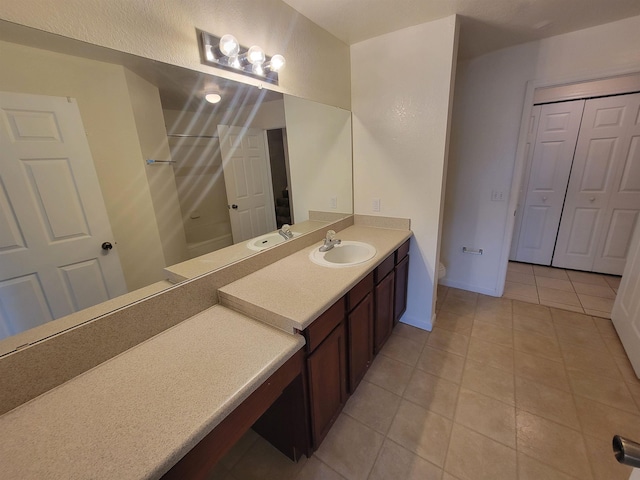 bathroom featuring toilet, vanity, and tile patterned floors