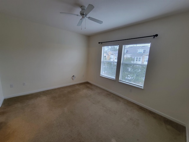 carpeted empty room with ceiling fan