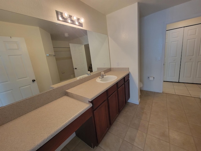 bathroom with tile patterned floors, vanity, and toilet