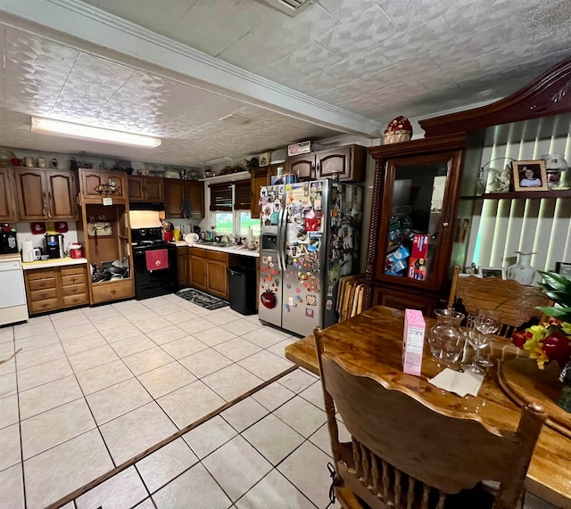 kitchen featuring black appliances, a textured ceiling, light tile patterned floors, sink, and dark brown cabinets