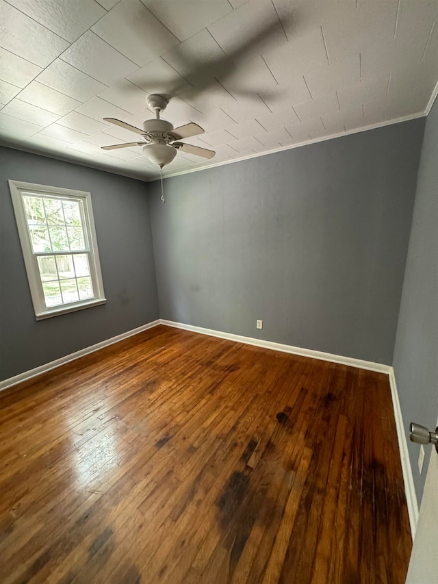 spare room featuring ceiling fan, hardwood / wood-style floors, and ornamental molding