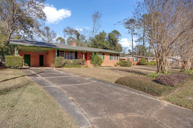 ranch-style home featuring a front yard and a carport