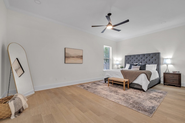 bedroom featuring crown molding, light hardwood / wood-style flooring, and ceiling fan