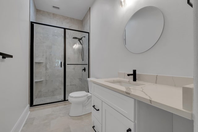 bathroom featuring vanity, an enclosed shower, and toilet