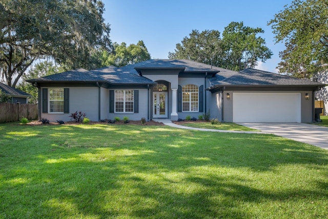 ranch-style home with a garage and a front yard