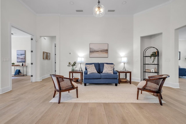 living room with crown molding and light hardwood / wood-style flooring