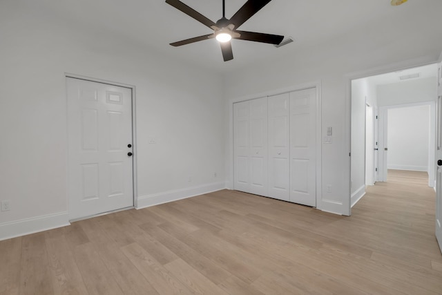 unfurnished bedroom with ceiling fan and light wood-type flooring