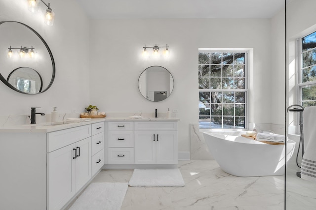 bathroom with vanity and a bath