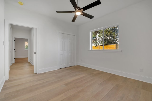 unfurnished bedroom featuring ceiling fan, light hardwood / wood-style floors, and a closet