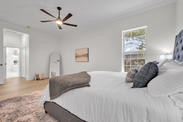 bedroom featuring multiple windows, crown molding, ceiling fan, and light hardwood / wood-style floors