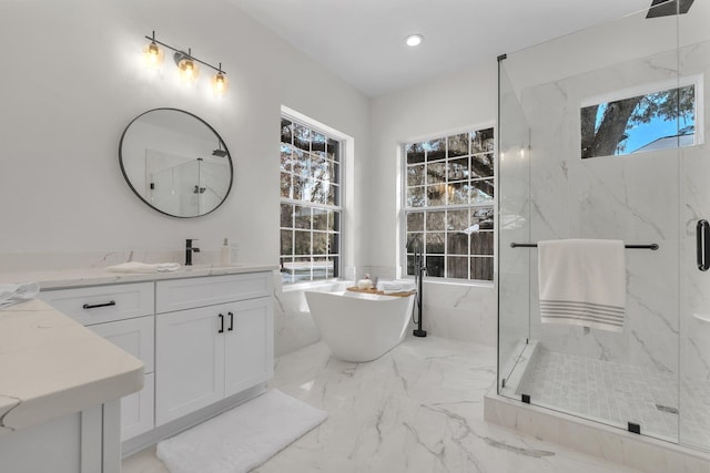 bathroom featuring vanity, a healthy amount of sunlight, and plus walk in shower