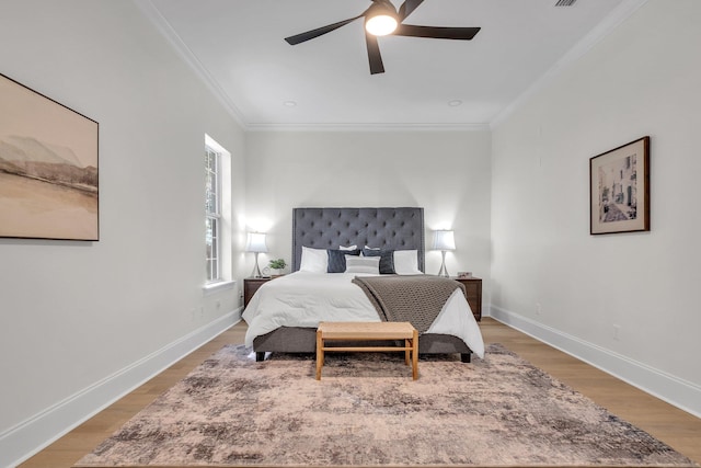 bedroom featuring crown molding, ceiling fan, and light hardwood / wood-style floors