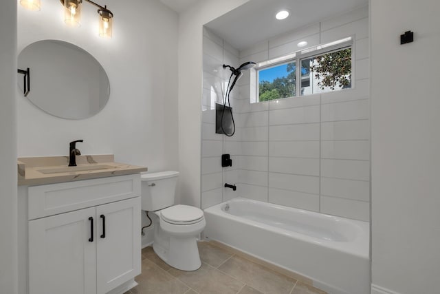 full bathroom featuring tiled shower / bath combo, vanity, tile patterned flooring, and toilet