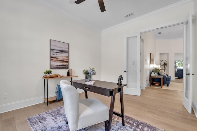 office featuring crown molding, ceiling fan, light wood-type flooring, and french doors