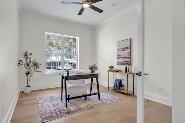 home office with ornamental molding, ceiling fan, and light hardwood / wood-style floors