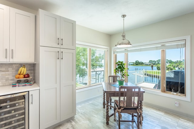 dining room with a water view and beverage cooler