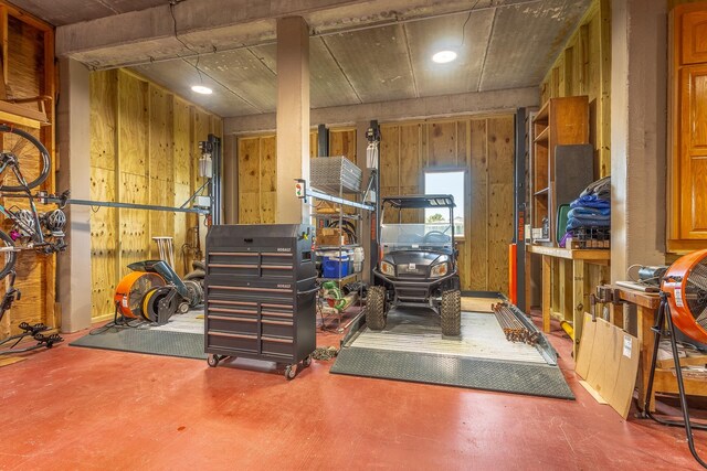 basement featuring wooden walls