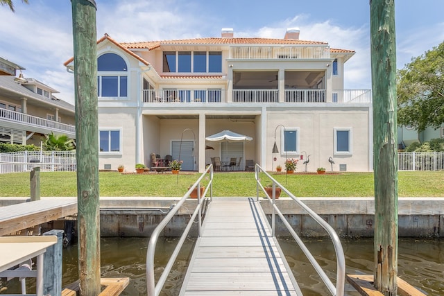 view of dock featuring a yard and a water view