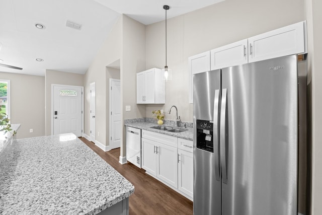 2328 Southampton Dr, Tallahassee, FL 32311 - kitchen with stainless steel appliances, a sink, light stone counters, dark wood finished floors, and white cabinets
