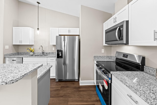 2328 Southampton Dr, Tallahassee, FL 32311 - kitchen with appliances with stainless steel finishes, a sink, dark wood-style floors, vaulted ceiling, and white cabinetry