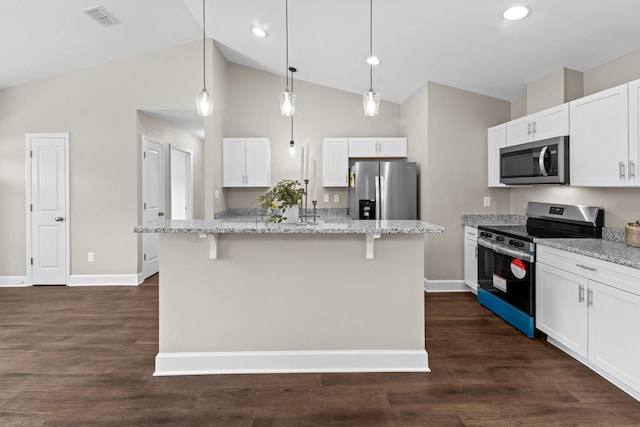 2328 Southampton Dr, Tallahassee, FL 32311 - kitchen featuring appliances with stainless steel finishes, baseboards, a kitchen breakfast bar, white cabinetry, and light stone counters
