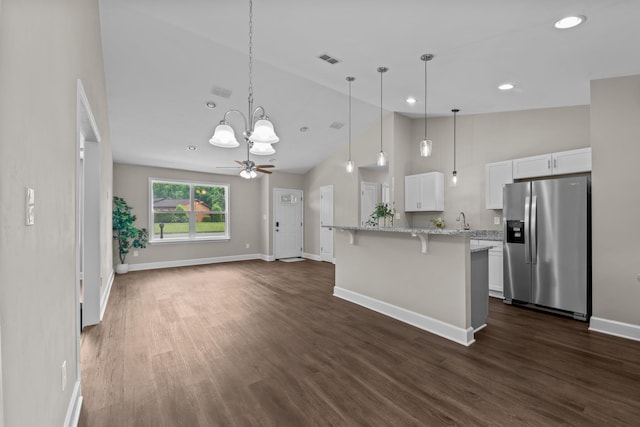2328 Southampton Dr, Tallahassee, FL 32311 - kitchen with stainless steel fridge with ice dispenser, a kitchen breakfast bar, baseboards, a chandelier, and white cabinetry