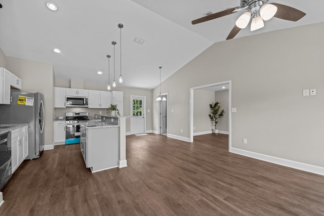 2328 Southampton Dr, Tallahassee, FL 32311 - kitchen featuring appliances with stainless steel finishes, a kitchen island, ceiling fan, vaulted ceiling, and white cabinetry