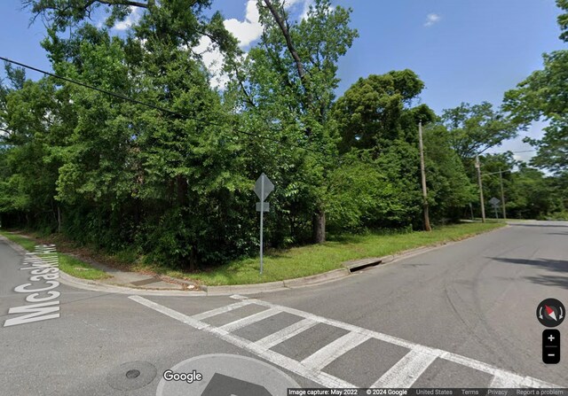 view of street with curbs and traffic signs