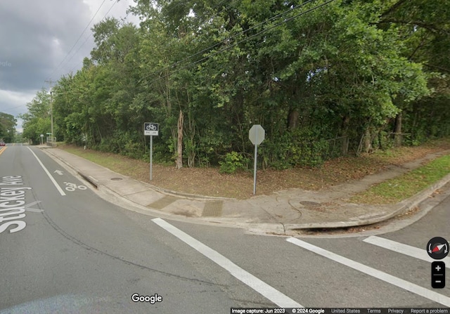 view of road with sidewalks and curbs