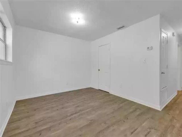 2705 Lake Henrietta St, Tallahassee, FL 32310 - empty room featuring baseboards and wood finished floors