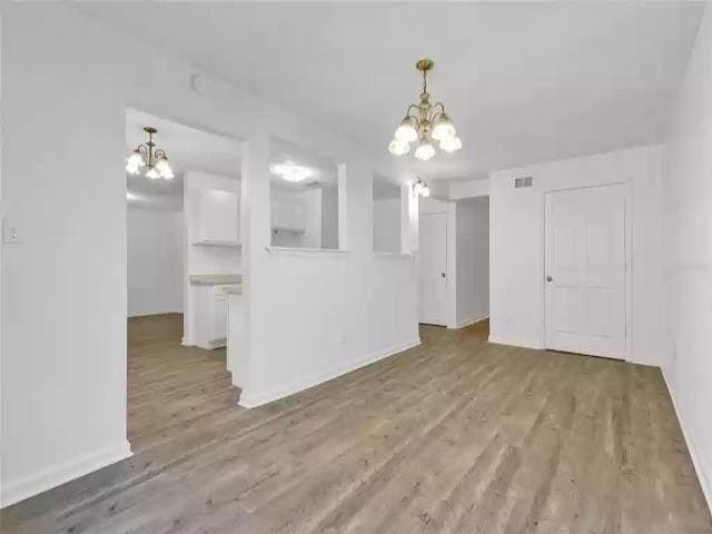 2705 Lake Henrietta St, Tallahassee, FL 32310 - interior space with visible vents, baseboards, an inviting chandelier, and wood finished floors