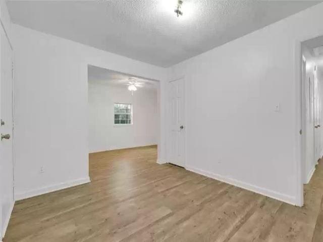 2705 Lake Henrietta St, Tallahassee, FL 32310 - spare room with a textured ceiling, wood finished floors, and baseboards