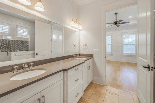 bathroom featuring ceiling fan, double vanity, tile patterned flooring, and a sink