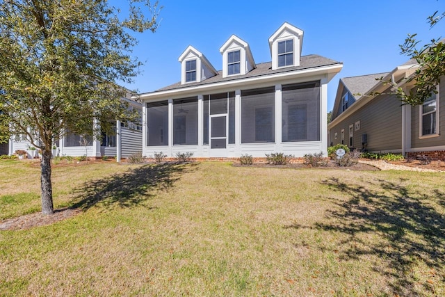 view of front of property featuring a sunroom and a front yard