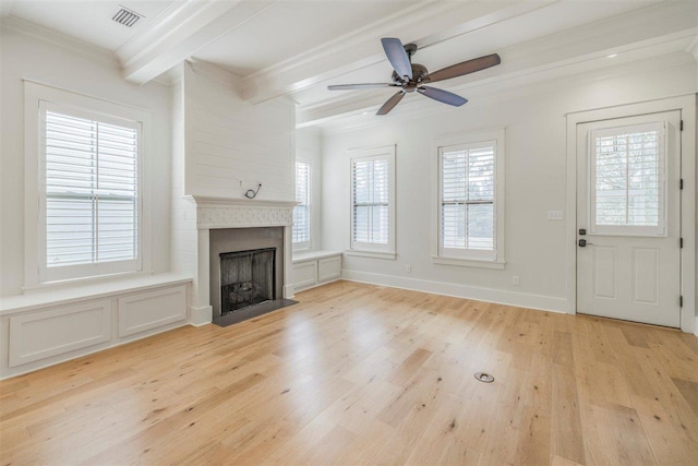 unfurnished living room featuring a fireplace, light wood finished floors, visible vents, ornamental molding, and beamed ceiling