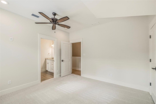 unfurnished bedroom with visible vents, baseboards, connected bathroom, ceiling fan, and carpet