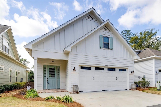 modern farmhouse with driveway, board and batten siding, and an attached garage