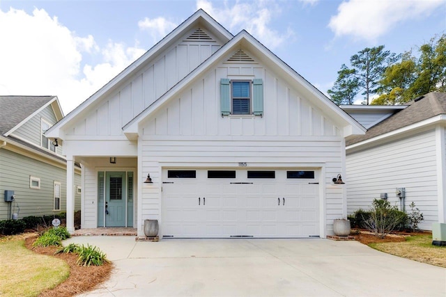 modern inspired farmhouse with a garage, driveway, and board and batten siding