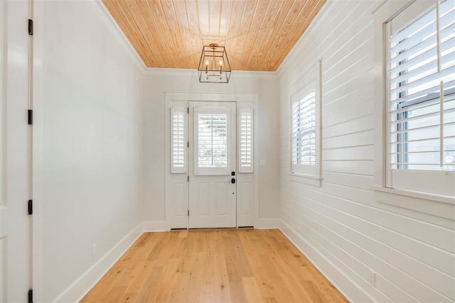 entryway with wooden ceiling, baseboards, ornamental molding, and light wood finished floors