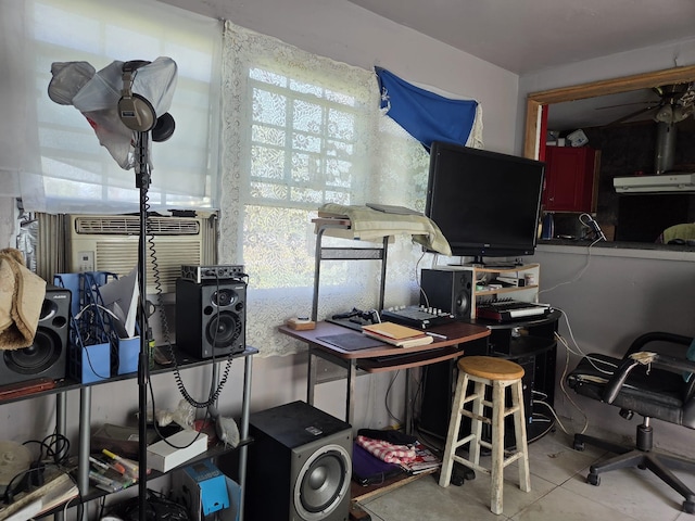 office with ceiling fan and concrete flooring