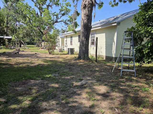 view of yard featuring central air condition unit