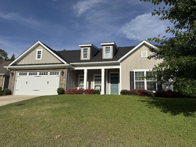 craftsman inspired home with a front yard, brick siding, board and batten siding, concrete driveway, and an attached garage