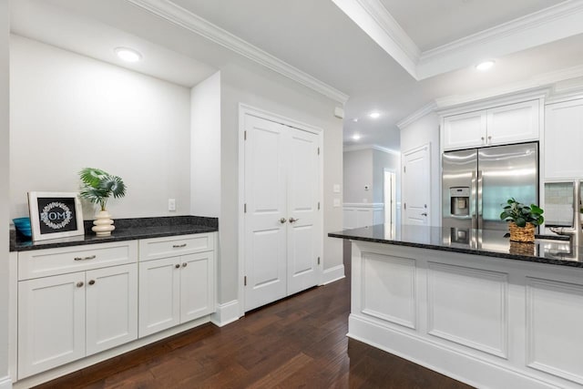 712 Sydney Dr, Tallahassee, FL 32317 - kitchen with stainless steel refrigerator with ice dispenser, crown molding, dark wood-type flooring, recessed lighting, and dark stone counters