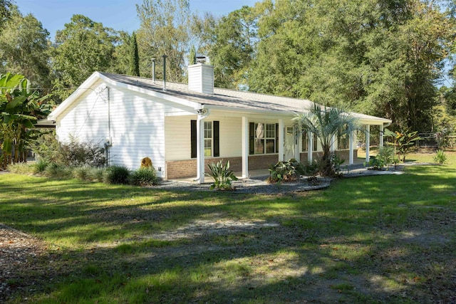 rear view of property with a lawn