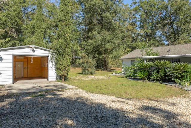 view of yard featuring a garage and an outdoor structure